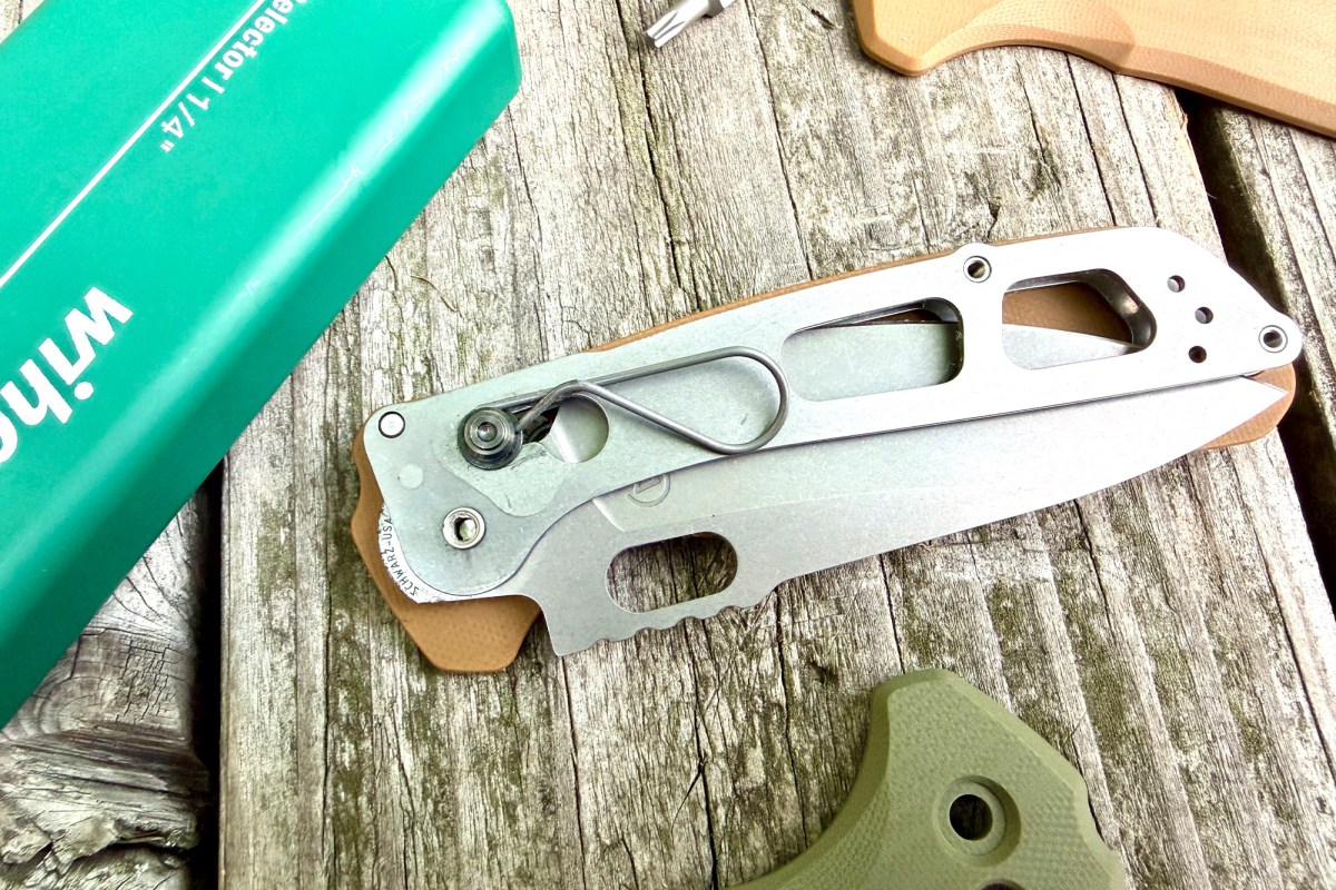 Disassembled Schwarz Enduro knife showing the internal frame, spring, and blade mechanism