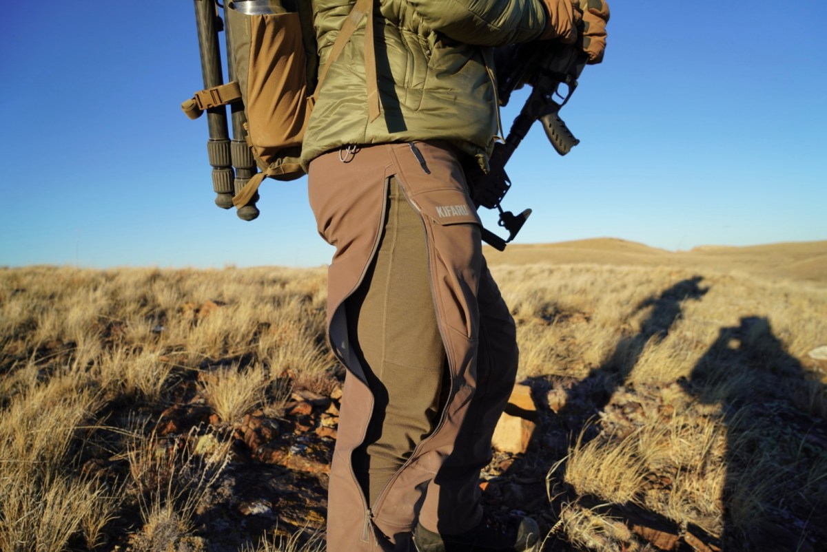 A set of hunting pants with the hip vents opened, showcasing a hidden baselayer