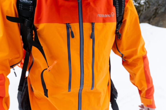 a gearjunkie tester wearing the Norrona Trollvegen Pro Light with detail on the chest zippers 