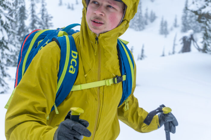 a gearjunkie tester wearing a yellow patagonia hardshell while ski touring in washington state