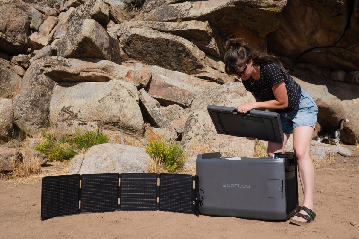EcoFlow portable fridge connected to a folding solar panel at camp