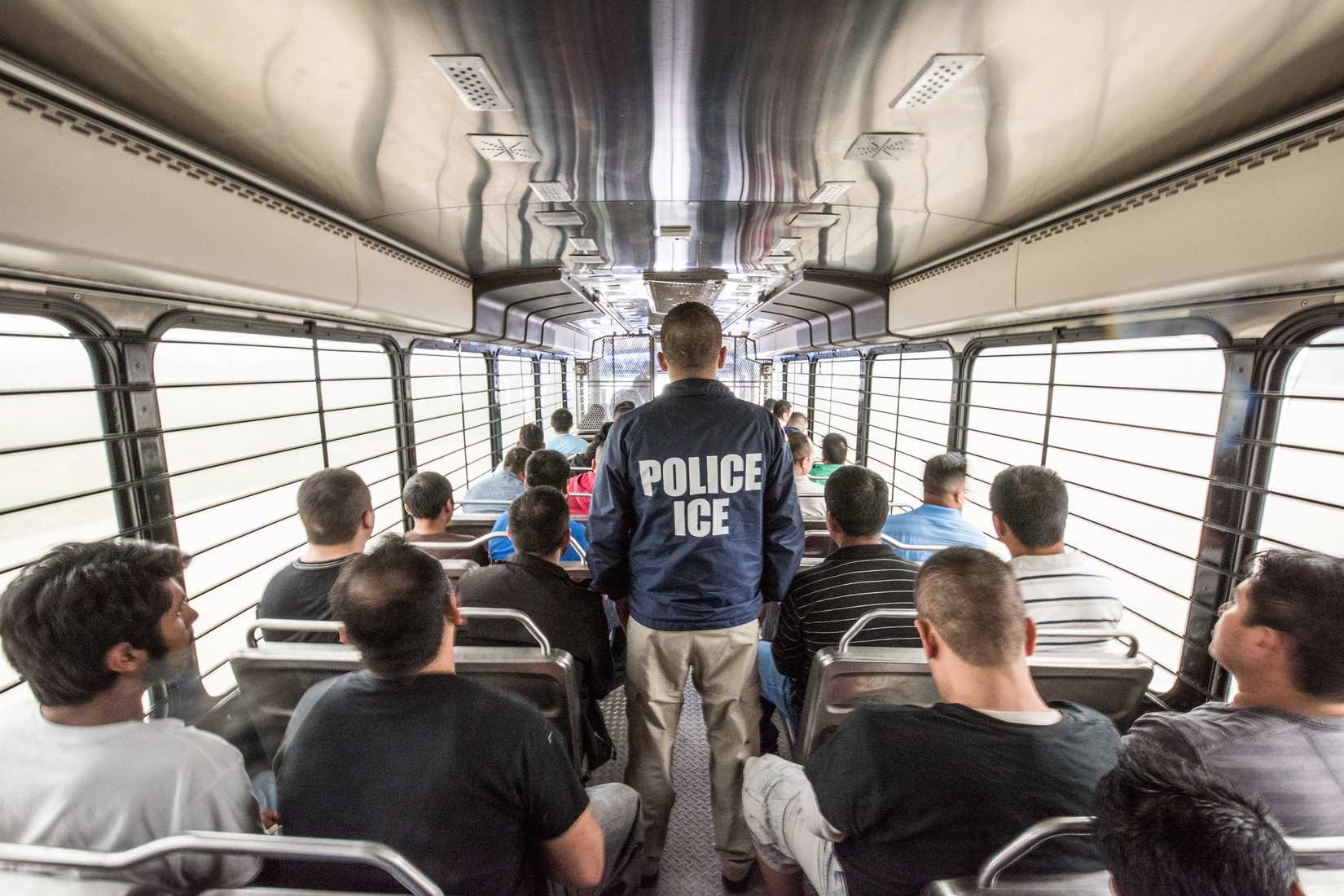 An_ERO_officer_escorts_aliens_headed_to_an_ICE_detention_facility