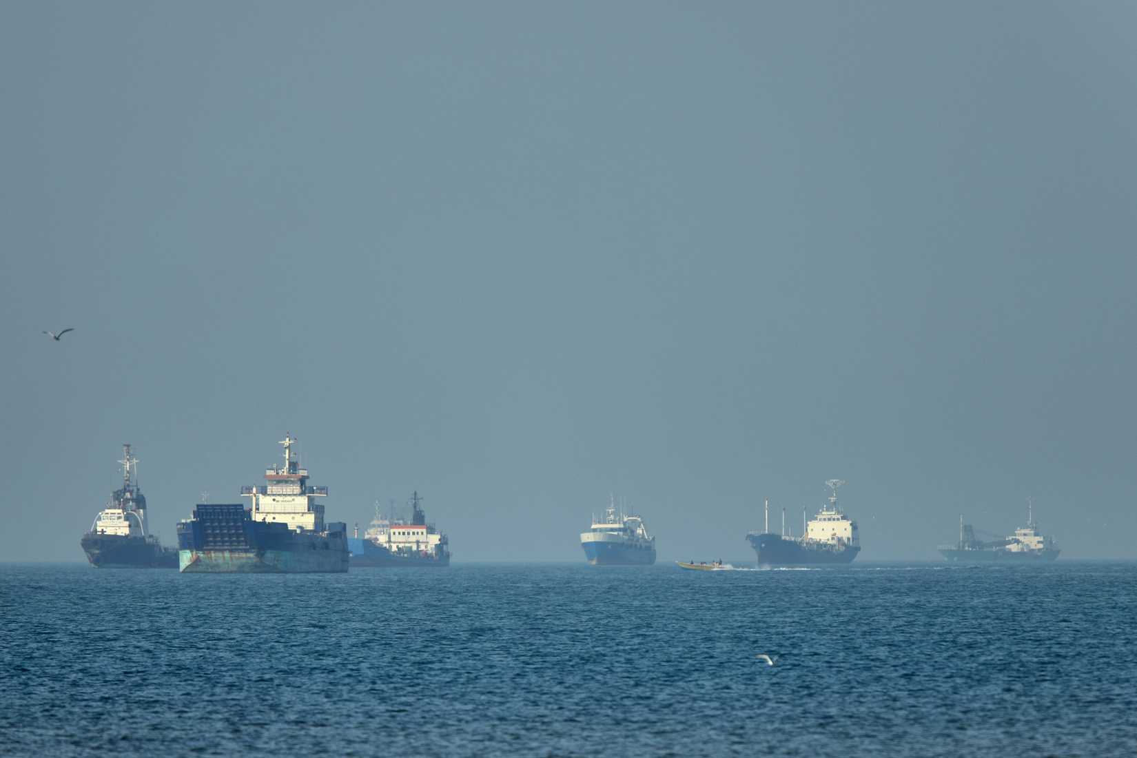 Cargo ships sit at anchor in the Strait of Hormuz.