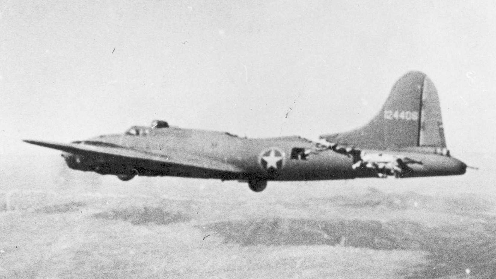 The damaged B-17 All American III flies with its rear fuselage nearly severed after a midair collision.