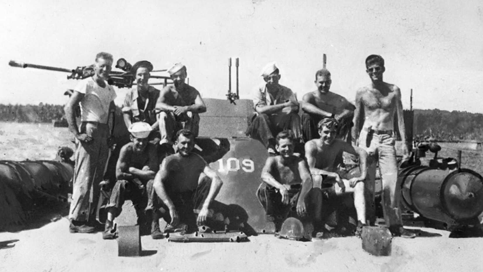 John F. Kennedy and nine PT-109 crew members pose on their patrol boat in the Solomon Islands.