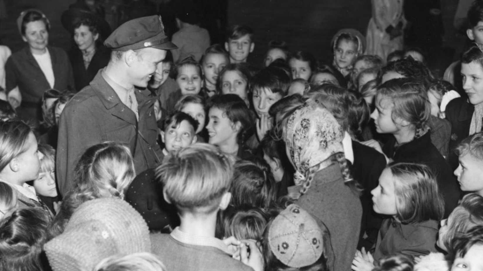 Lt. Gail Halvorsen stands surrounded by German children during the Berlin Airlift.