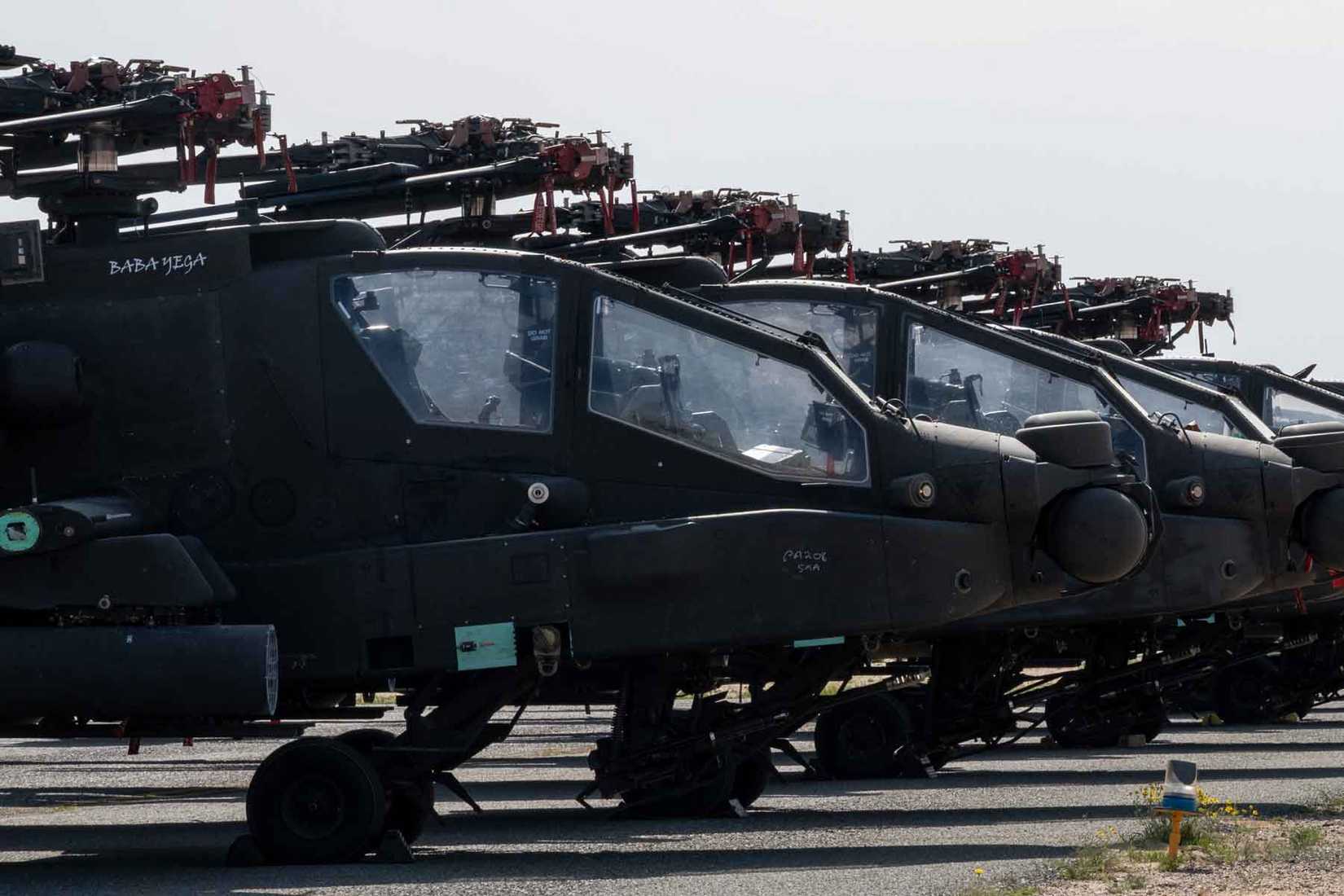 U.S. Army AH-64 Apaches sit on the flight line at Ali Al Salem Air Base, Kuwait.
