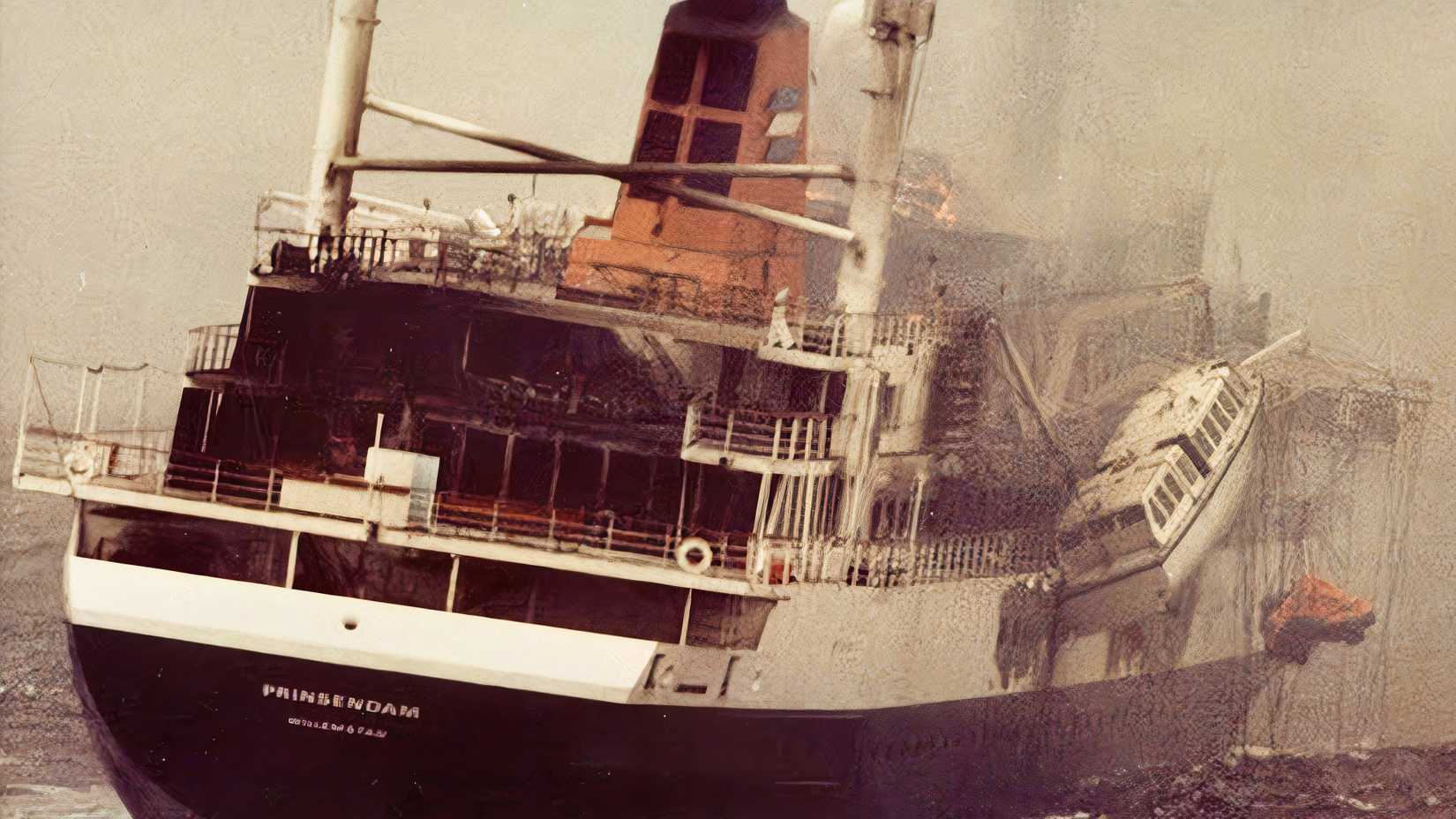 The cruise ship Prinsendam lists heavily and burns in the Gulf of Alaska during the October 1980 rescue operation.