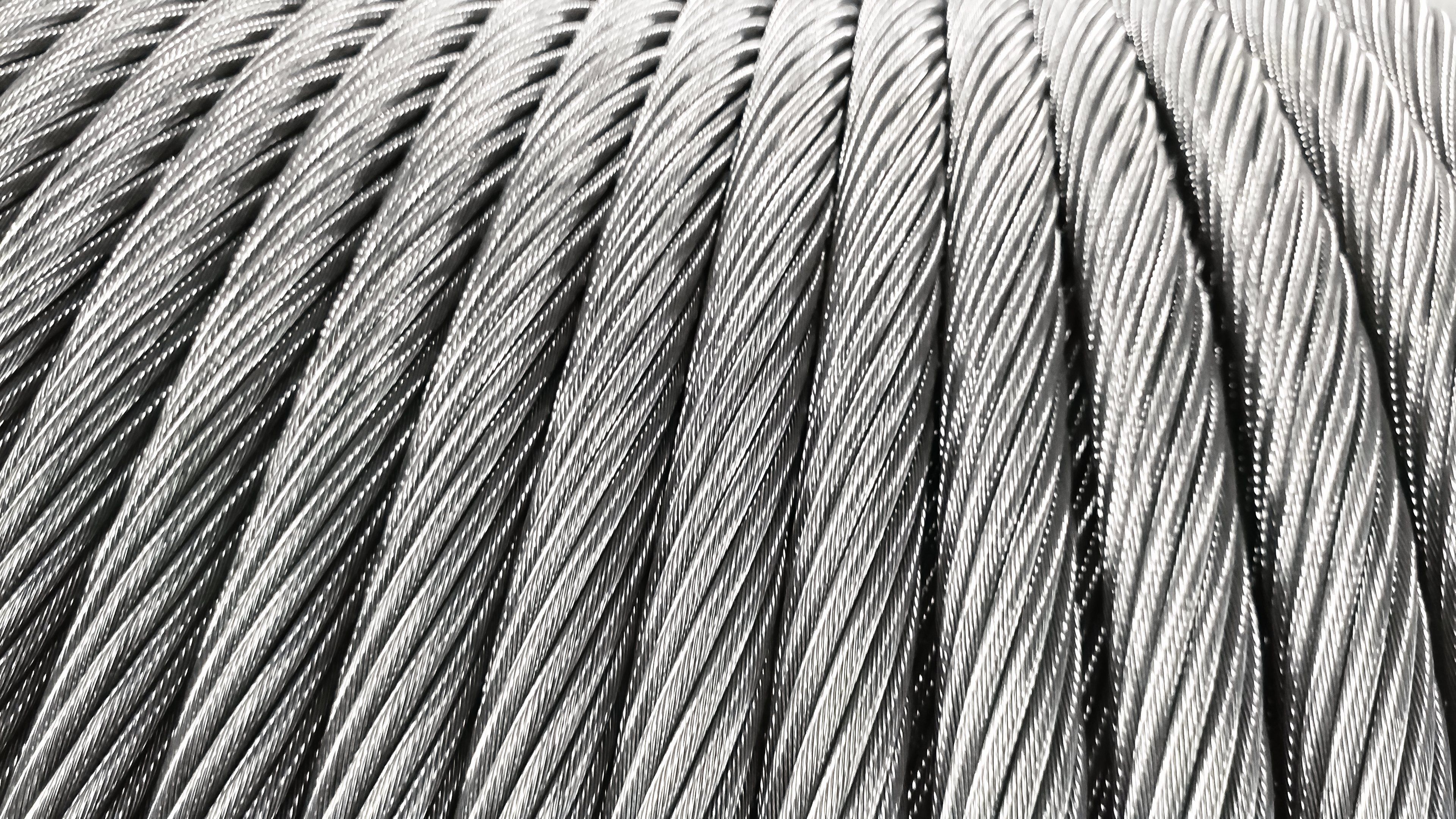 A close view shows tightly twisted strands of stainless steel wire rope.