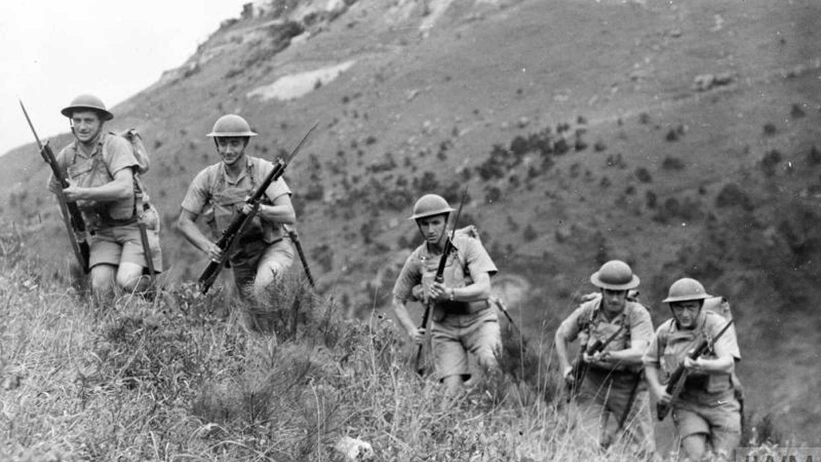 Canadian soldiers carrying rifles train in the hills of Hong Kong in 1941 before the Japanese invasion.