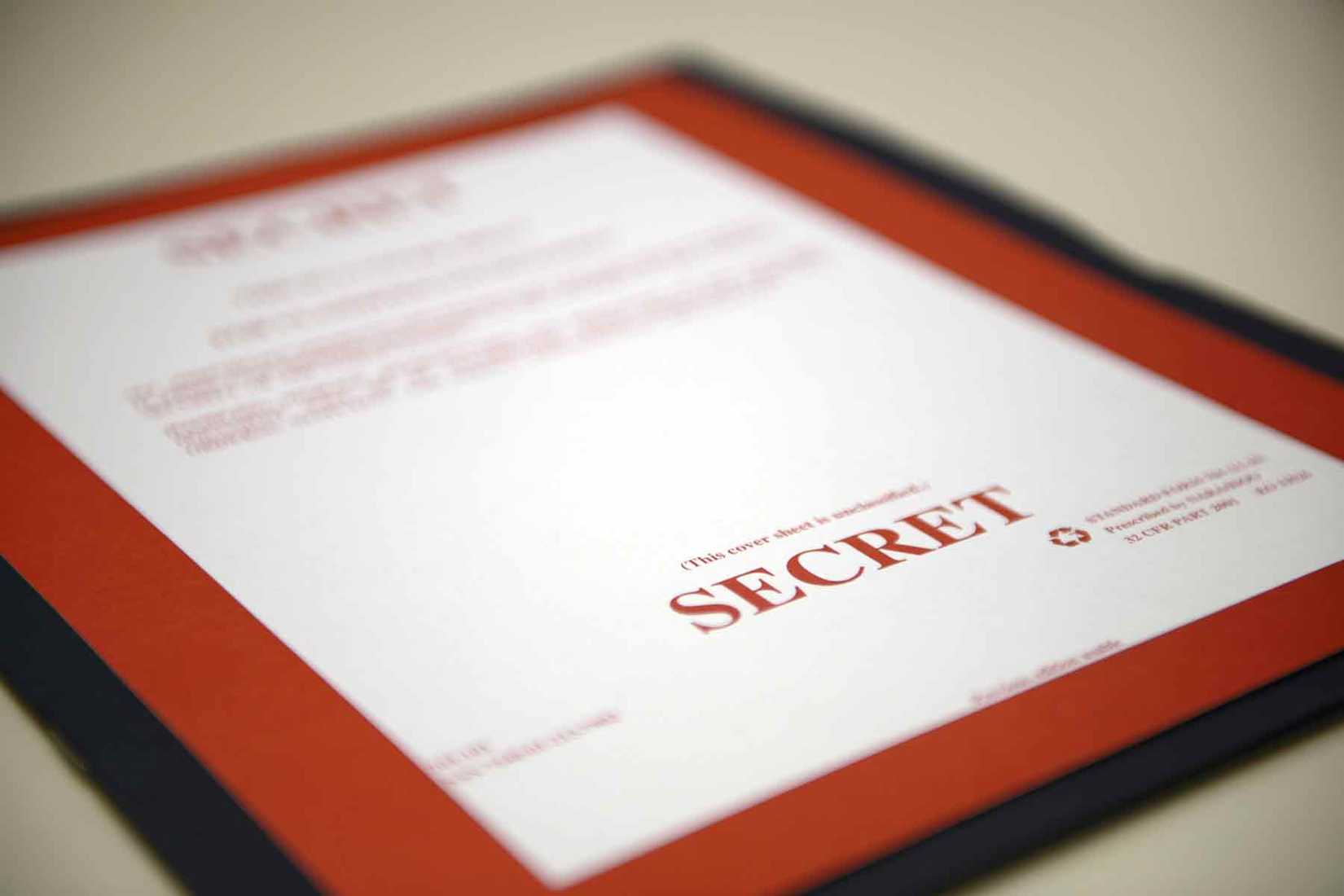 A “secret” cover sheet designating a folder that contains classified material.